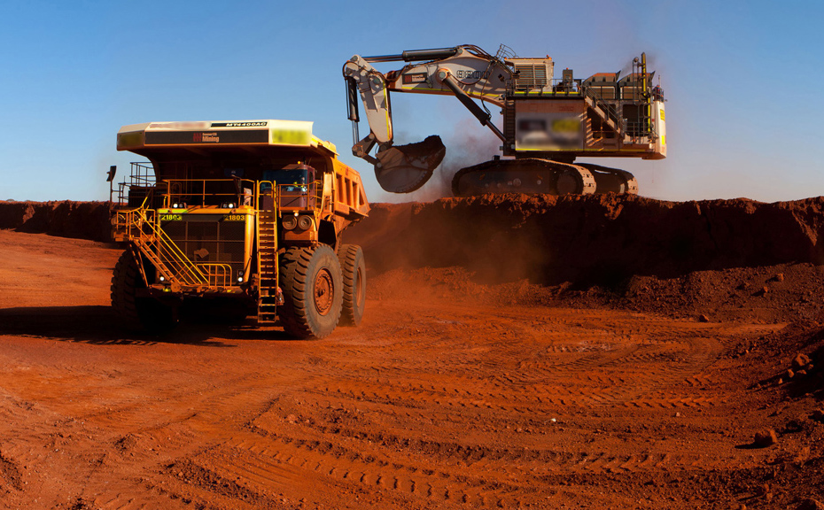 An earth mover shifts dirt into a truck in the Pilbara